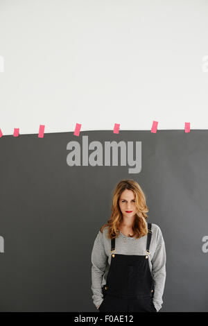 Mid adult woman standing with hands in pockets Banque D'Images