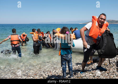 Chios, Grèce. 21 juillet, 2015. Les réfugiés en provenance de Syrie arrivent dans overladen canot en caoutchouc sur l'île grecque de Chios. Les 60 occupants du bateau sont arrivés après 5 heures en mer et trois jours à pied soulagés et heureux de poser le pied sur le sol européen après une évasion de la combattre en Syrie. Chios, Grèce. Crédit : Mike Abrahams/Alamy Live News Banque D'Images