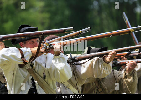 Les soldats de l'armée continentale pendant la guerre révolutionnaire mousquets tirant au creux de reconstitution Jockey au parc historique national de Morristown, New Jersey, USA Banque D'Images