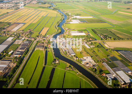 Vue aérienne sur la banlieue d'Amsterdam avec des canaux, les maisons , les champs et les bâtiments industriels. Holland Banque D'Images