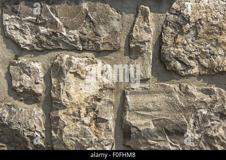 Mur en pierre rustique comme arrière-plan. Banque D'Images