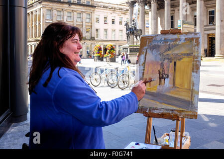 Glasgow, Ecosse, Royaume-Uni. Août 15, 2015. Près de 150 artistes sont venus à Glasgow pour prendre part à l 'art' Peintre rapide concurrence avec l'objectif étant de faire une peinture saisir l'esprit de la ville de Glasgow, terminé en 1 jour. Les artistes ont attiré beaucoup de curiosité et l'intérêt des touristes et habitants, lorsqu'ils ont mis en place dans divers endroits de la ville. Tous les ouvrages terminés seront mis en exposition sur Dimanche 16 août au Royal Concert Hall, Sauchiehall Street, Glasgow lorsque de nombreuses peintures seront en vente. Credit : Findlay/Alamy Live News Banque D'Images