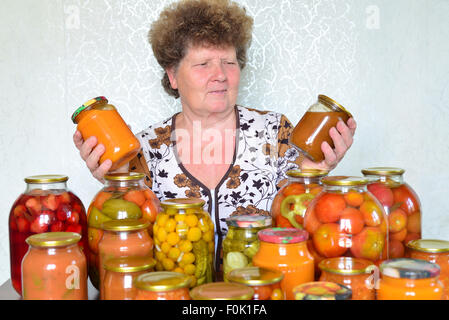 Femme au foyer mature avec des légumes en conserve maison Banque D'Images