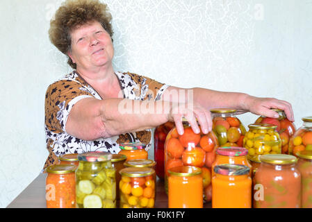 Femme au foyer mature avec des légumes en conserve maison Banque D'Images