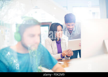 Creative business people using digital tablet in office Banque D'Images