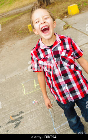 Cute boy playing hopscotch Banque D'Images