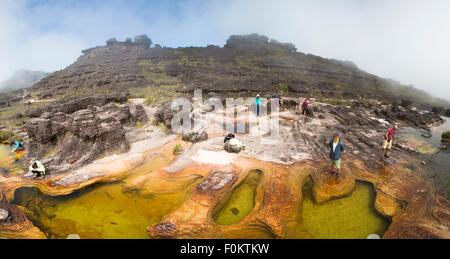 Panorama de groupe de randonneurs à la formations rocheuses naturelles sur le sommet du mont Roraima qui sert de piscines naturelles. Banque D'Images