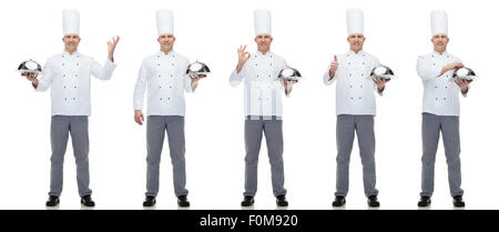 Happy male chef cook holding cloche Banque D'Images