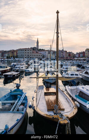 Coucher de soleil sur de petits bateaux ancrés au-dessous de l'église de St Euphémie, Rovinj, Istrie, Croatie Banque D'Images