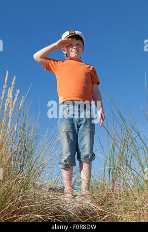 Jeune garçon saluant dans les dunes, Rostock, Rostock, Mecklembourg-Poméranie occidentale, Allemagne Banque D'Images