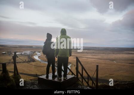 Les touristes, hommes et femmes de prendre des photographies à partir de la plate-forme d'observation à Seljalandsfoss, Islande Banque D'Images