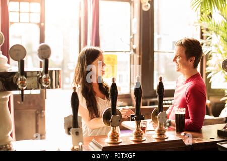 Couple talking in bar Banque D'Images