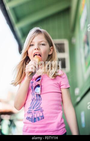 Portrait of young girl eating icecream