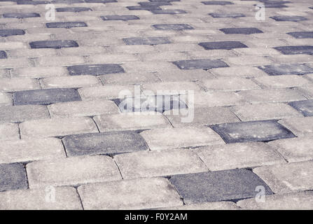 Brique gris stone street road. La lumière, la texture de la chaussée trottoir Banque D'Images