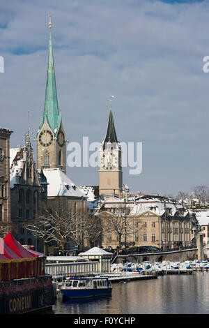 Vue sur la vieille ville de Zurich, en Suisse, au cours de l'hiver, à l'aval de la rivière Limmat et Fraumunster avec saint Pierre. Banque D'Images