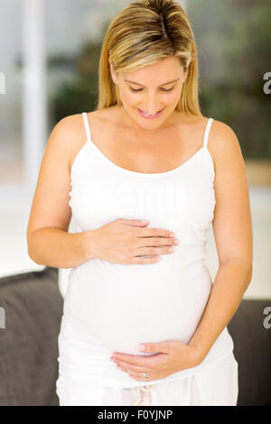 Happy pregnant woman looking at son ventre Banque D'Images