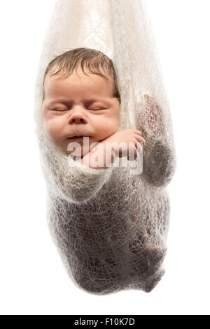 Cute baby boy couchage hamac pendu en couverture de laine de swing, tourné en studio et isolé sur fond blanc Banque D'Images