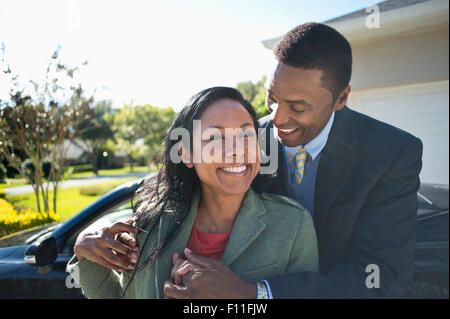 Couple hugging près de cabriolet Banque D'Images