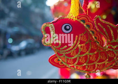 Poisson rouge festif, un poisson souvenir aux couleurs vives en dehors d'une boutique dans le vieux quartier historique de Hanoi, au Vietnam. Banque D'Images