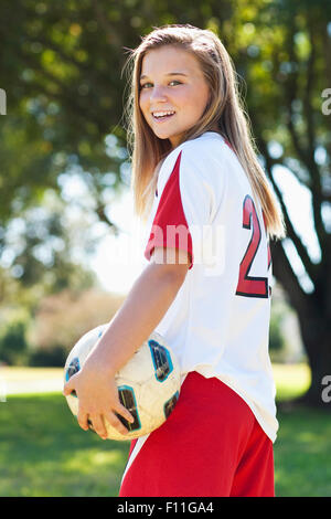 Young soccer player holding ball Banque D'Images