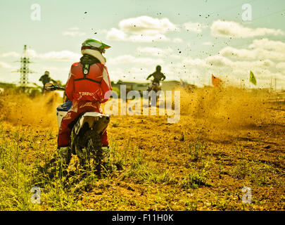 Motocross caucasienne biker en attente sur race course Banque D'Images