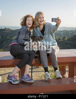 Les femmes de race blanche en tenant sur une colline selfies Banque D'Images