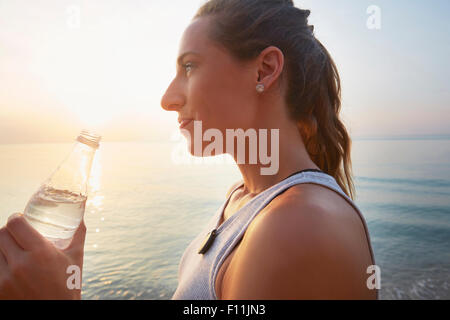 Bouteille d'eau potable de l'athlète sur la plage Banque D'Images