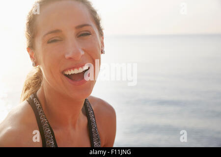 Close up of woman laughing on beach Banque D'Images