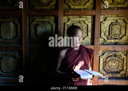 Moine asiatique en formation holding book à temple Banque D'Images