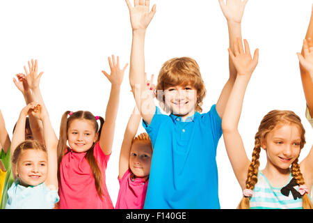 Cute kids debout sur les mains levées avec blanc Banque D'Images