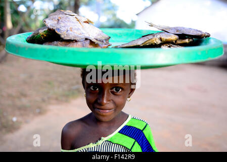 Les jeunes poissons vendeur bac transportant sur la tête, Iemberem village. Parc national de Cantanhez, Guinée-Bissau, décembre 2013. Banque D'Images