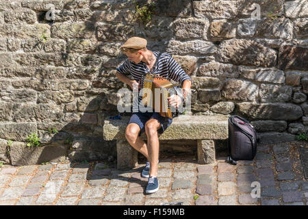 Musicien de rue sur la rue du Petit Fort, Dinan, dans le Nord-Ouest France Juillet 2015 Phillip Roberts Banque D'Images