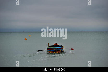 Brighton UK Lundi 31 août 2015 - Un pêcheur têtes hors de la plage de Brighton Bank Holiday Août tôt ce lundi matin dans l'espoir d'attraper une pause dans le temps humide avec des prévisions pour le sud-est étant pour de fortes pluies et d'orages possible Crédit : Simon Dack/Alamy Live News Banque D'Images