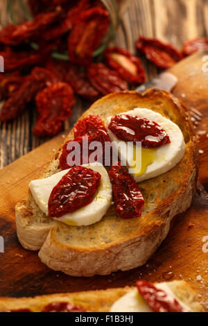 Bruschettas aux tomates séchées, mozzarella, l'ail et l'huile d'olive. La cuisine traditionnelle italienne faite de sandwich Ciabatta grillées. Banque D'Images