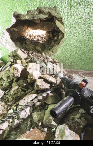 Le forage d'un grand trou dans le mur. Percer Banque D'Images