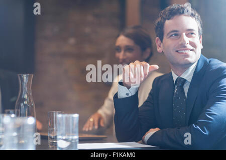 Smiling businessman in conference room meeting Banque D'Images