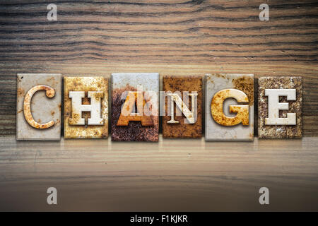 Le mot "CHANGER", écrit en métal rouillé type letterpress assis sur un rebord en bois, arrière-plan. Banque D'Images