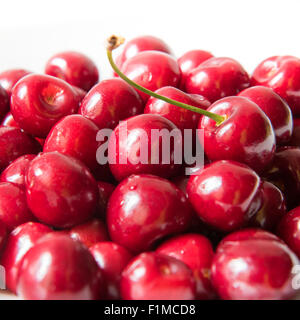 Bol d cerries frais rouge sur fond blanc Banque D'Images