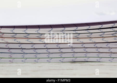 Image en gros plan d'une pile de carnets colorés sur une table en bois blanc. Banque D'Images
