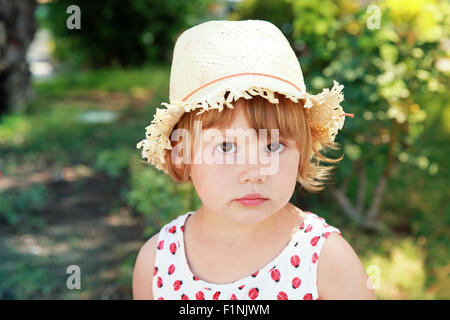 Caucase cute little girl in straw hat, portrait d'été en plein air Banque D'Images