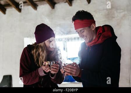 Jeune couple de la randonnée, dans un abri pour se reposer, Honister Mine d'Ardoise, Keswick, Lake District, Cumbria, Royaume-Uni Banque D'Images