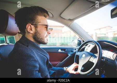 Jeune homme élégant driving car Banque D'Images