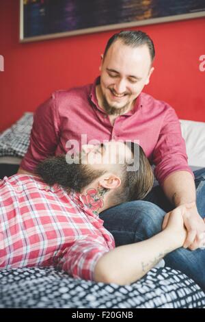 Gay couple chatting in bedroom Banque D'Images