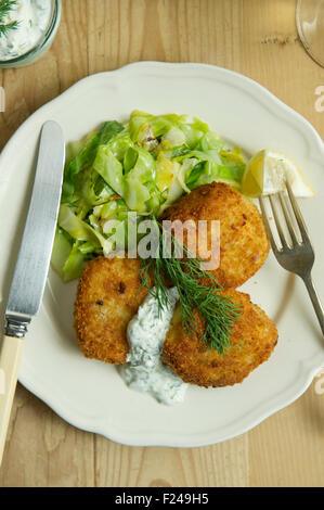 Fishcakes épicé avec le chou et la sauce tartare. Un repas de fruits de mer propose une cuisine britannique de la farine de poisson plat repas petite assiette manger manger Banque D'Images