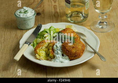 Fishcakes épicé avec le chou et la sauce tartare. Un repas de fruits de mer propose une cuisine britannique de la farine de poisson plat repas petite assiette manger manger Banque D'Images