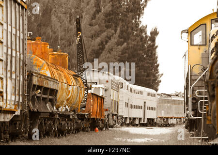 Vieux trains avec des voitures et wagons-citernes sur une trainyard. Banque D'Images