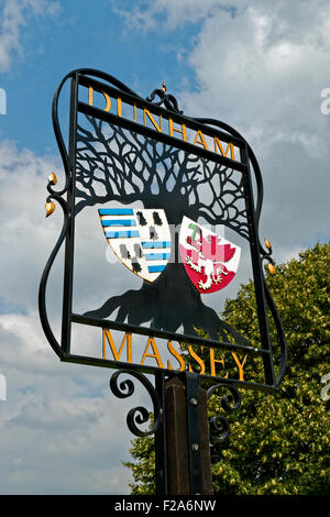 Panneau du village de Dunham Massey avec le blason de la ville de Dunham, Altrincham, Trafford dans le Grand Manchester. Banque D'Images