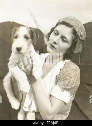 Jeune femme tenant son fox terrier à poil dur (OLVI007 OU  F848) Banque D'Images