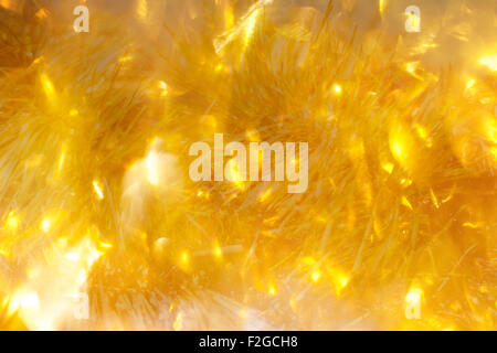 Lumières de Noël doré doux - arrière-plan flou de fête. Banque D'Images