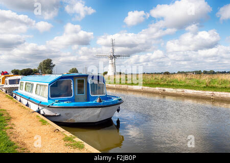 Bateaux sur la rivière Thurne sur les Norfolk Broads avec la Thurne Moulin en arrière-plan Banque D'Images